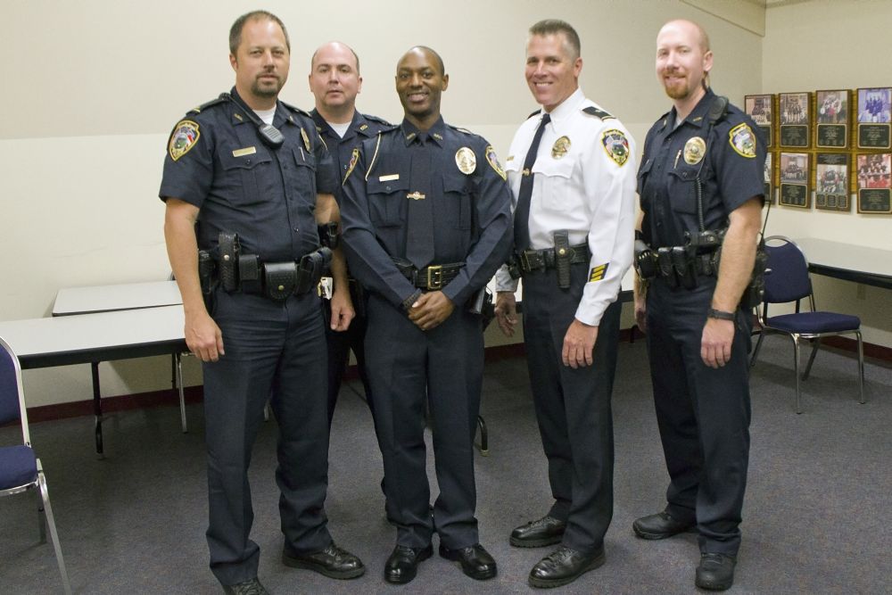 Officer Demond Conner shown in the center next to the chief.